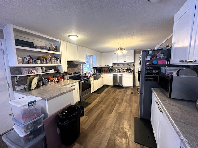 306 10th Ave, Edgemont, SD 57735 - kitchen with appliances with stainless steel finishes, a chandelier, dark wood finished floors, white cabinets, and a textured ceiling