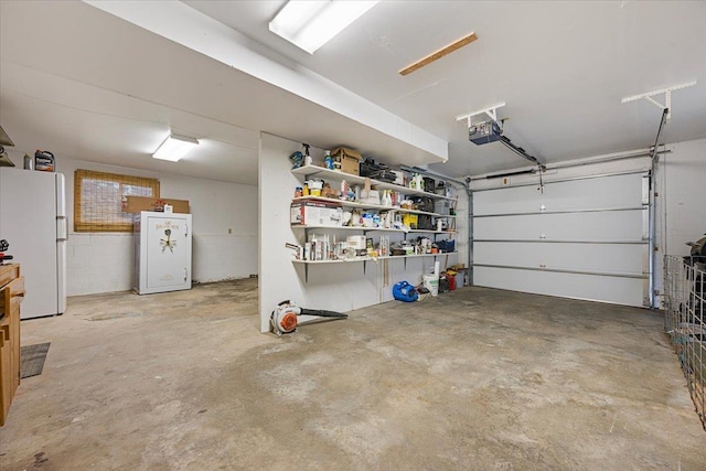 garage with freestanding refrigerator, a garage door opener, and refrigerator