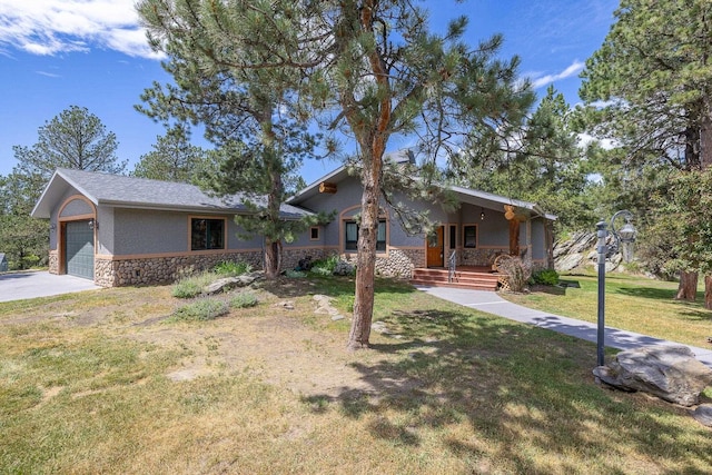 25189 Steckelberg Valley Rd, Custer, SD 57730 - view of front of house with a front lawn, stone siding, stucco siding, concrete driveway, and covered porch