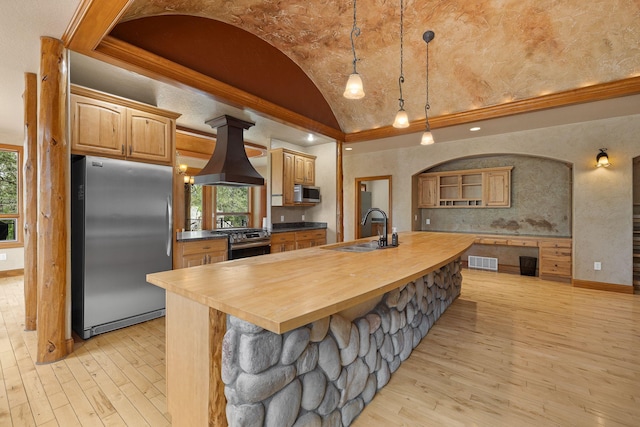 25189 Steckelberg Valley Rd, Custer, SD 57730 - kitchen featuring visible vents, island range hood, vaulted ceiling, a sink, and stainless steel appliances