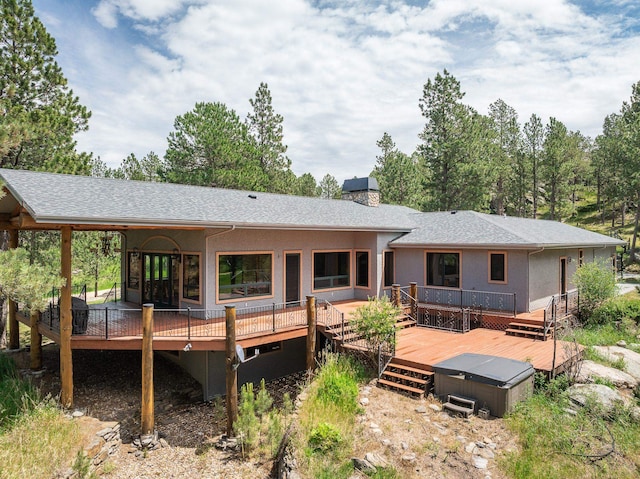 25189 Steckelberg Valley Rd, Custer, SD 57730 - rear view of property with stucco siding, a wooden deck, a shingled roof, and a chimney