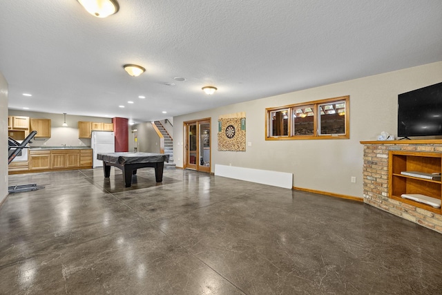 25189 Steckelberg Valley Rd, Custer, SD 57730 - playroom featuring pool table, baseboards, concrete flooring, and a textured ceiling