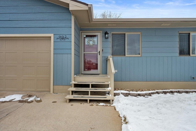 902 Yuma St, Belle Fourche, SD 57717 - snow covered property entrance featuring an attached garage