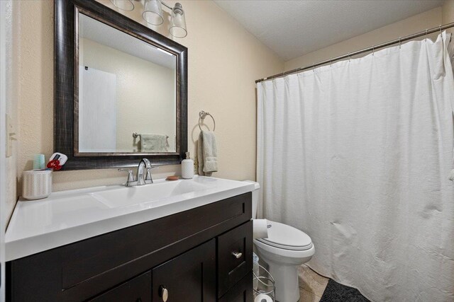 902 Yuma St, Belle Fourche, SD 57717 - bathroom featuring vanity, tile patterned floors, and toilet