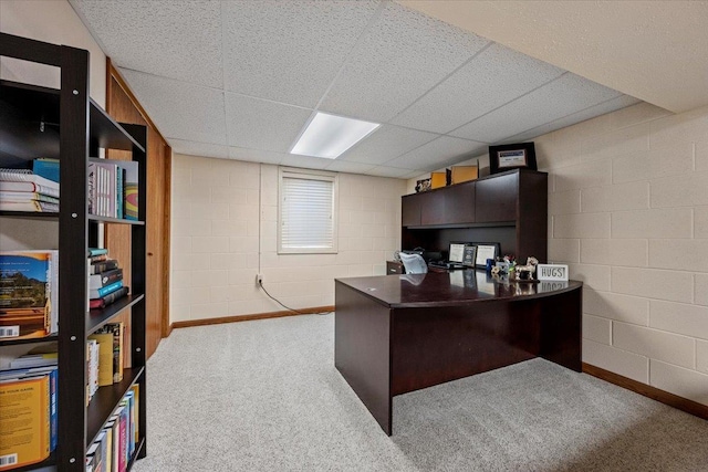 902 Yuma St, Belle Fourche, SD 57717 - home office featuring concrete block wall, baseboards, carpet flooring, and a paneled ceiling