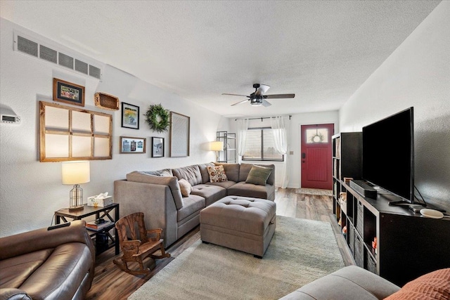 902 Yuma St, Belle Fourche, SD 57717 - living room featuring visible vents, a ceiling fan, a textured ceiling, and wood finished floors