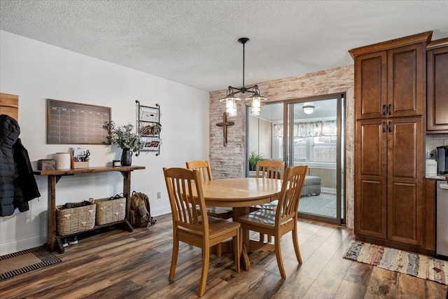 902 Yuma St, Belle Fourche, SD 57717 - dining area featuring a textured ceiling, baseboards, and wood finished floors