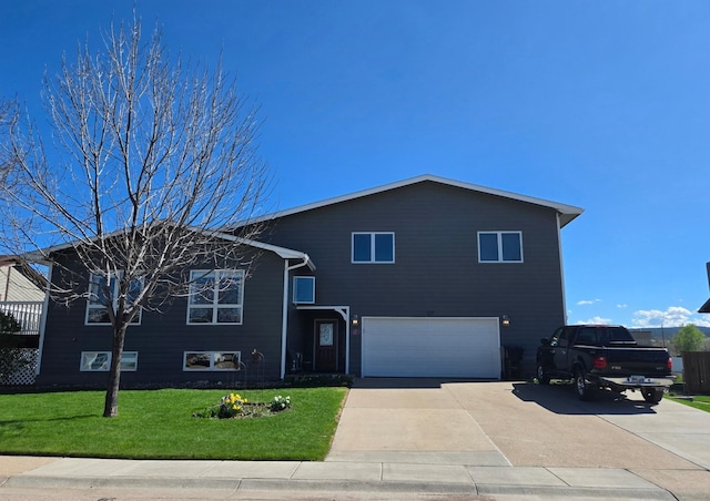 split level home with a garage, driveway, and a front yard