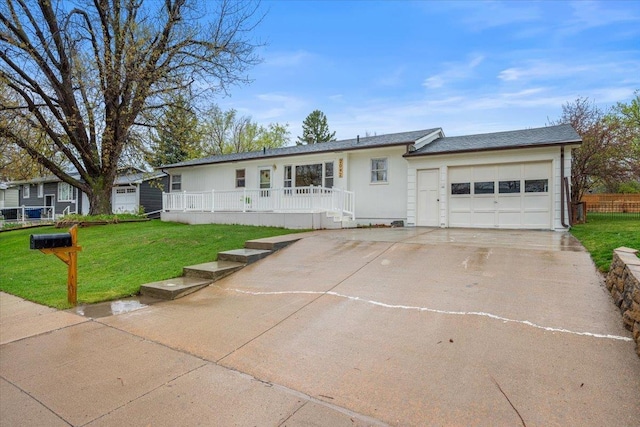 2042 12th Ave, Belle Fourche, SD 57717 - ranch-style home featuring concrete driveway, an attached garage, a porch, and a front lawn