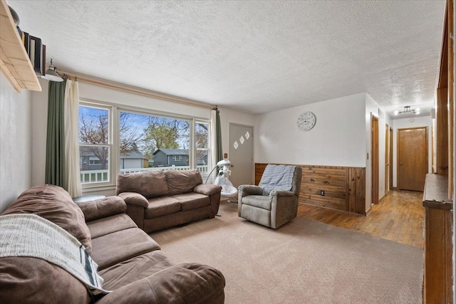 2042 12th Ave, Belle Fourche, SD 57717 - living room with light wood-style flooring, a textured ceiling, and light carpet