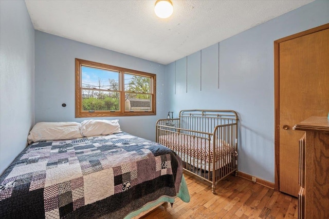 2042 12th Ave, Belle Fourche, SD 57717 - bedroom featuring baseboards and wood finished floors