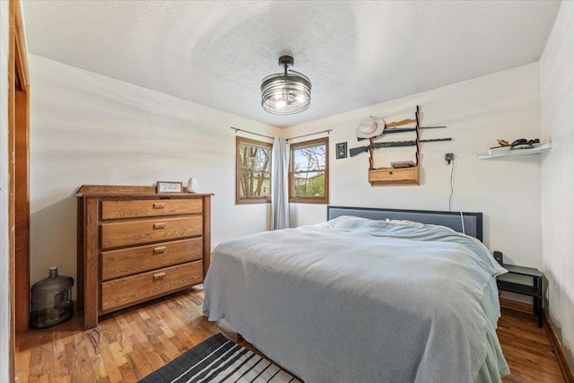 2042 12th Ave, Belle Fourche, SD 57717 - bedroom with a textured ceiling and wood finished floors
