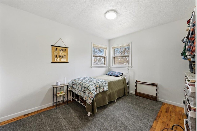 2042 12th Ave, Belle Fourche, SD 57717 - bedroom with baseboards, a textured ceiling, and wood finished floors