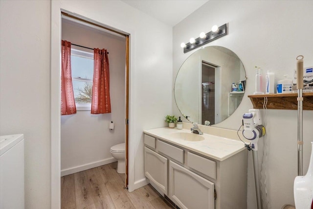 2042 12th Ave, Belle Fourche, SD 57717 - bathroom featuring baseboards, vanity, toilet, and wood finished floors