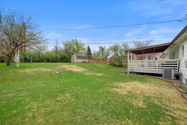 2042 12th Ave, Belle Fourche, SD 57717 - view of yard featuring a storage unit, an outdoor structure, a deck, and cooling unit