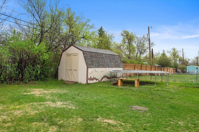 2042 12th Ave, Belle Fourche, SD 57717 - view of shed featuring a fenced backyard and a trampoline