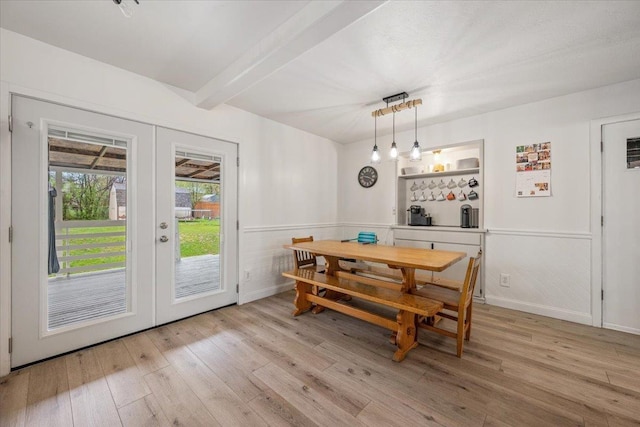 2042 12th Ave, Belle Fourche, SD 57717 - dining space featuring french doors, baseboards, wood finished floors, and beam ceiling