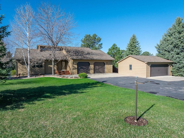 view of front of property with a garage and a front yard