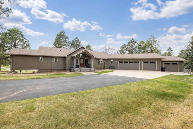 ranch-style home with concrete driveway, an attached garage, and a front lawn