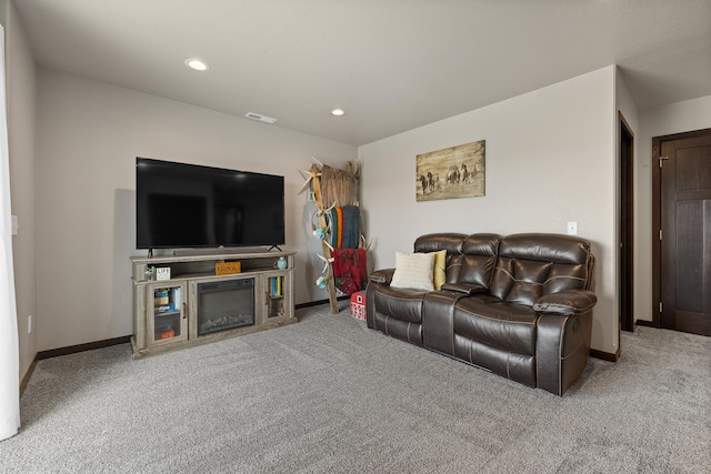 6461 Receda St, Rapid City, SD 57703 - carpeted living room featuring a glass covered fireplace, baseboards, recessed lighting, and visible vents