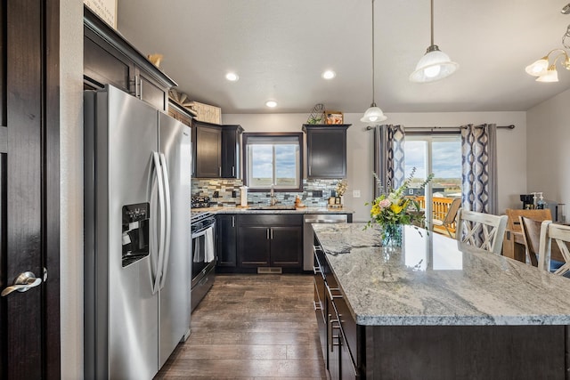 6461 Receda St, Rapid City, SD 57703 - kitchen featuring plenty of natural light, appliances with stainless steel finishes, a center island, a sink, and dark wood-style floors