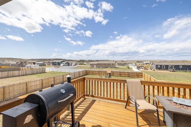 6461 Receda St, Rapid City, SD 57703 - deck featuring grilling area, a fenced backyard, an outdoor fire pit, a yard, and a residential view