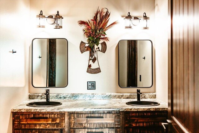 bathroom with a sink and double vanity