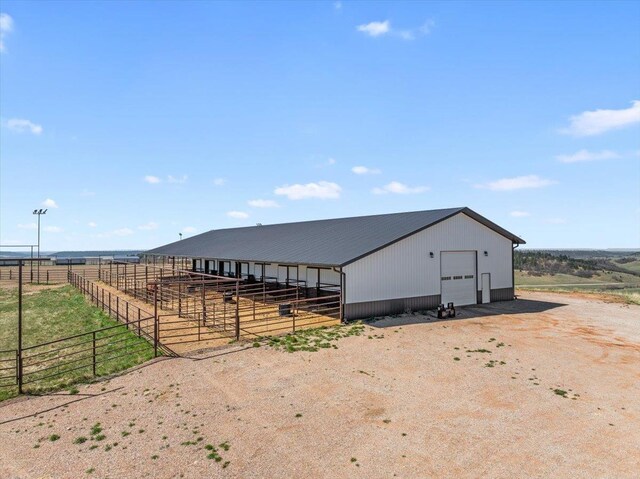 view of outbuilding with an exterior structure, an outbuilding, and driveway