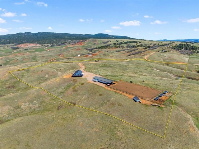 drone / aerial view with a mountain view and a rural view