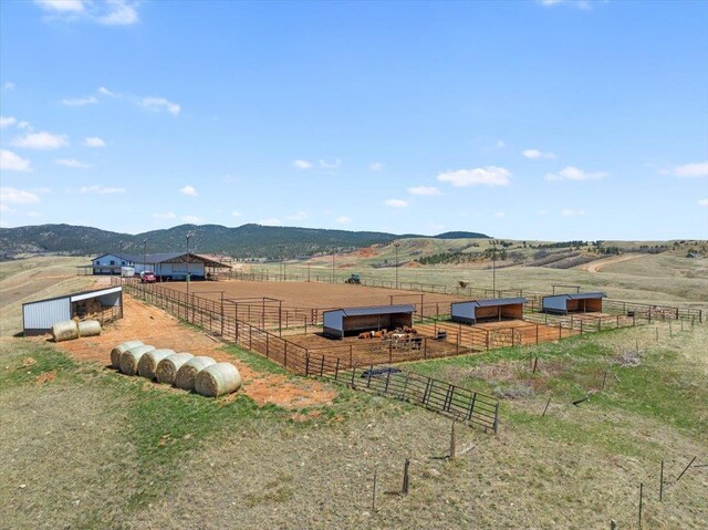view of yard with an outbuilding, a pole building, an exterior structure, and a rural view