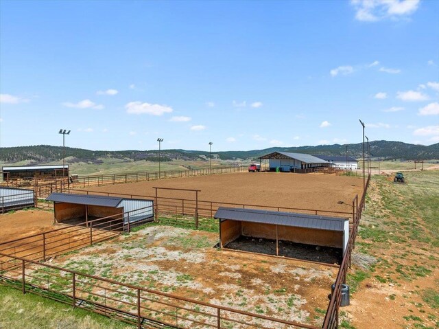 view of yard with an exterior structure, a rural view, and an enclosed area