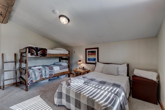 bedroom with baseboards, carpet, and lofted ceiling