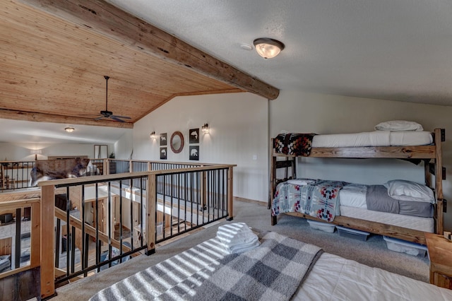 carpeted bedroom featuring vaulted ceiling with beams and baseboards