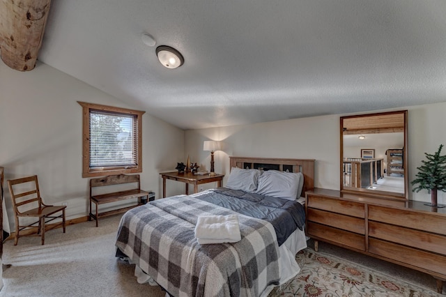 bedroom featuring carpet flooring, a textured ceiling, baseboards, and lofted ceiling