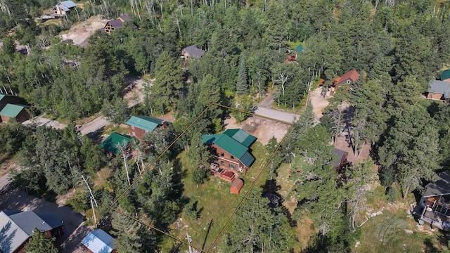 drone / aerial view featuring a forest view
