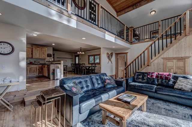 living room featuring stairs, recessed lighting, wood finished floors, a towering ceiling, and wood ceiling