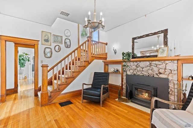 1019 Fulton St, Rapid City, SD 57701 - living area with wood-type flooring, an inviting chandelier, stairs, and visible vents