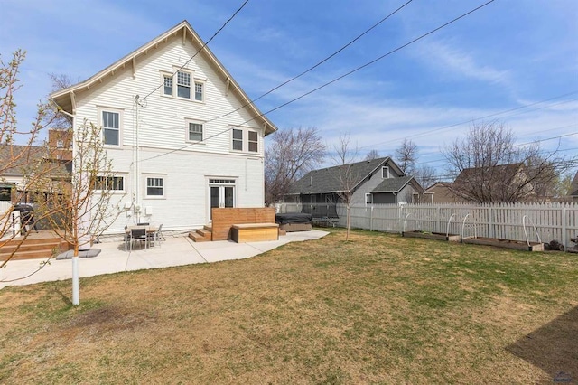 1019 Fulton St, Rapid City, SD 57701 - back of property featuring a lawn, a fenced backyard, entry steps, and a patio area