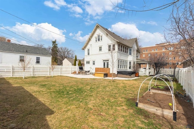 1019 Fulton St, Rapid City, SD 57701 - back of property with a garden, a lawn, a hot tub, a fenced backyard, and a patio