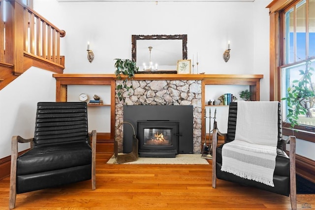1019 Fulton St, Rapid City, SD 57701 - sitting room featuring a stone fireplace, stairs, and wood finished floors