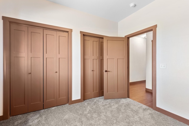 2900 Westview Ave, Spearfish, SD 57783 - unfurnished bedroom featuring light colored carpet, baseboards, and two closets