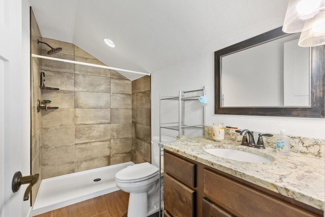 2900 Westview Ave, Spearfish, SD 57783 - bathroom featuring vanity, wood finished floors, toilet, a tile shower, and vaulted ceiling