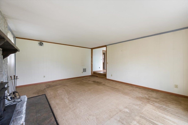 1112 Elkhorn St, Belle Fourche, SD 57717 - unfurnished living room featuring carpet floors, ornamental molding, baseboards, and visible vents