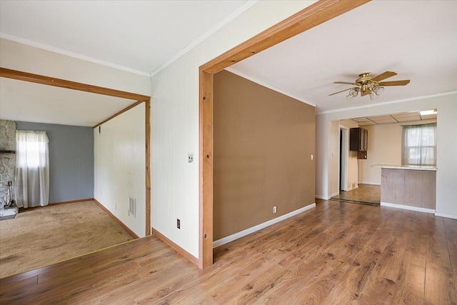 1112 Elkhorn St, Belle Fourche, SD 57717 - empty room with crown molding, wood finished floors, and a healthy amount of sunlight
