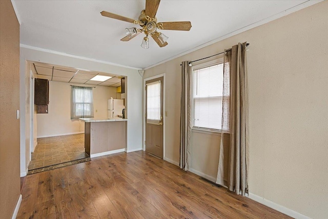 1112 Elkhorn St, Belle Fourche, SD 57717 - interior space featuring freestanding refrigerator, ceiling fan, baseboards, and wood finished floors