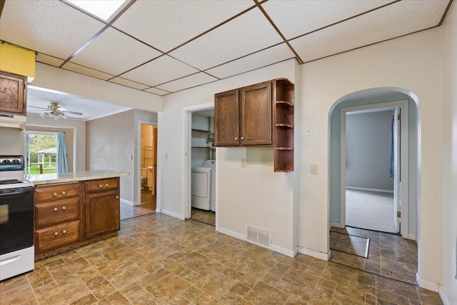 1112 Elkhorn St, Belle Fourche, SD 57717 - kitchen with stone finish flooring, white electric range oven, visible vents, and a drop ceiling