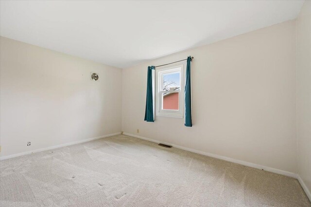 1112 Elkhorn St, Belle Fourche, SD 57717 - unfurnished room featuring light colored carpet, baseboards, and visible vents