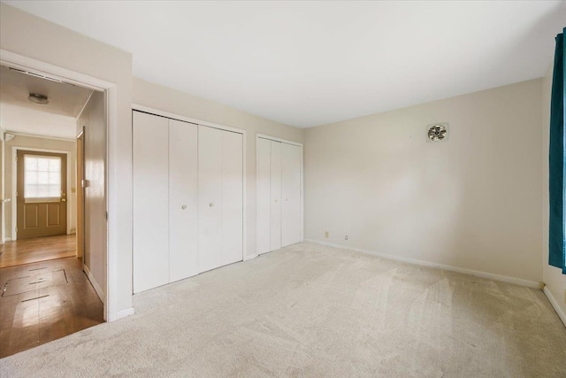 1112 Elkhorn St, Belle Fourche, SD 57717 - unfurnished bedroom featuring multiple closets, baseboards, and carpet