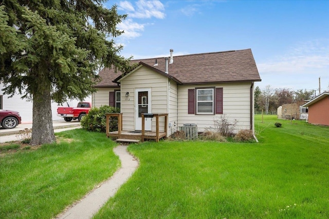 1112 Elkhorn St, Belle Fourche, SD 57717 - exterior space featuring roof with shingles and a yard