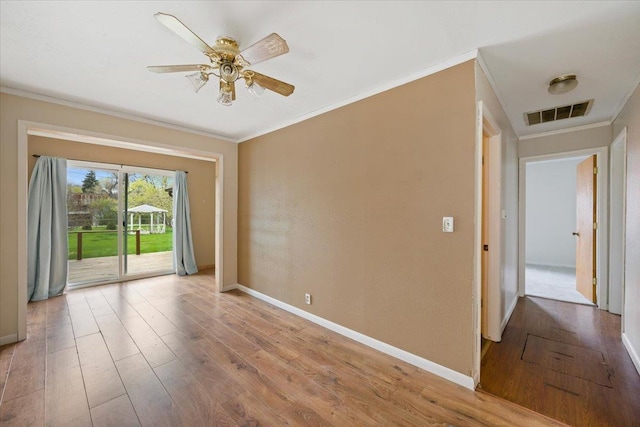 1112 Elkhorn St, Belle Fourche, SD 57717 - empty room featuring a ceiling fan, visible vents, crown molding, wood finished floors, and baseboards